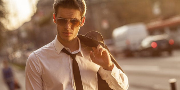 handsome businessman walking back home from work