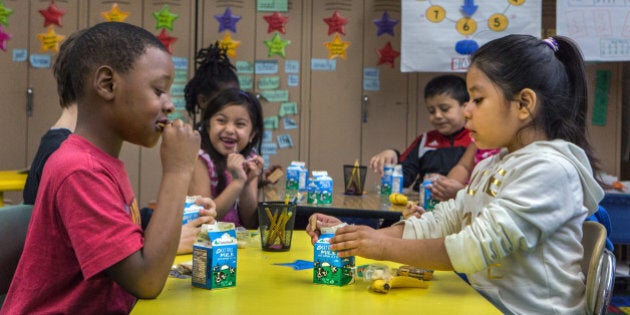 WASHINGTON, DC - MAR 14: Second graders Jaylon Holbrook and Kimberly Perez eat breakfast in their homeroom class at Bancroft Elementary School in Washington, DC, March 14, 2014. The national school breakfast program provides free breakfast to kids in need but at Bancroft where at least 40% of the students qualify for free breakfast, every student receives breakfast. In the last five years, DC leads the nation in terms of growth in participation in this program. (Photo by Evelyn Hockstein/For The Washington Post via Getty Images)