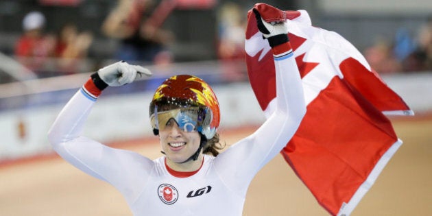 Canada's Monique Sullivan celebrates after winning the women's keirin track cycling competition at the Pan Am Games in Milton, Ontario, Friday, July 17, 2015. Sullivan won the gold medal. (AP Photo/Felipe Dana)