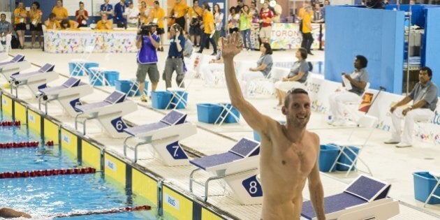 Gold medalist Ryan Cochrane of Canada waves to the crowd after competing in the Men's 15000M Freestyle finals at the 2015 Pan American Games in Toronto, Canada, July 18, 2015. AFP PHOTO/ JIM WATSON (Photo credit should read JIM WATSON/AFP/Getty Images)