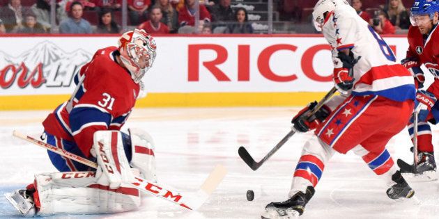 MONTREAL, QC - JANUARY 31: Carey Price #31 of the Montreal Canadiens makes a save off the shot by Jay Beagle #83 of the Washington Capitals in the NHL game at the Bell Centre on January 31, 2015 in Montreal, Quebec, Canada. (Photo by Francois Lacasse/NHLI via Getty Images)