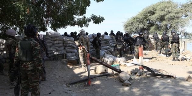 A picture taken on February 3, 2015 shows Chadian and Cameroonian soldiers trying to cross the El Beid bridge, which separates Fotokol from Gamboru. Chadian troops took control of the Nigerian border town of Gamboru on February 3 after launching a ground offensive against the jihadist Boko Haram group, an AFP journalist reported. AFP PHOTO / STEPHANE YAS (Photo credit should read STEPHANE YAS/AFP/Getty Images)