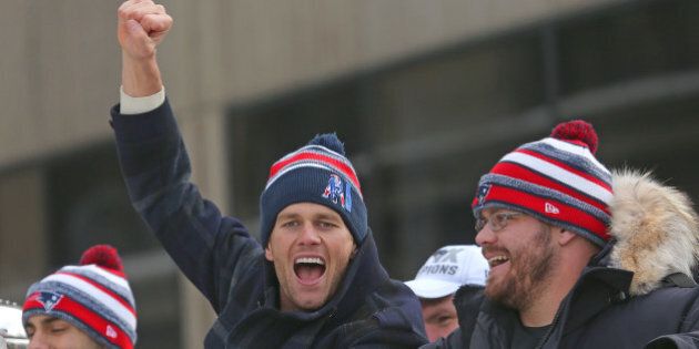 BOSTON - FEBRUARY 4: Patriots quarterback Tom Brady cheers as the Super Bowl victory parade continues down Tremont Street. (Photo by David L. Ryan/The Boston Globe via Getty Images)