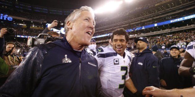 Seattle Seahawks head coach Pete Carroll and quarterback Russell Wilson celebrate after a 43-8 victory against the Denver Broncos in Super Bowl XLVIII at MetLife Stadium in East Rutherford, N.J., on Sunday, Feb. 2, 2014. (Tony Overman/The Olympian/MCT via Getty Images)
