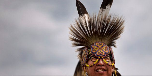 An Aboriginal man wears a traditional headdress during an event by Manito Abhee celebrating National Aboriginal Day in Winnipeg, Manitoba, Tuesday, June 21, 2011. More than 1 million Canadians are of Aboriginal origin, and the nation has more than 600 recognized First Nations governments. (AP Photo/Kevin Frayer)