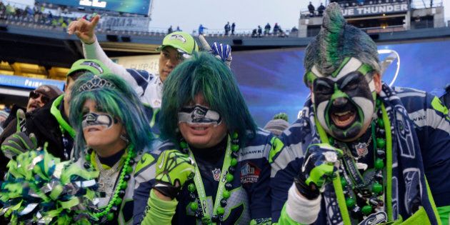 Seattle Seahawks fans celebrate after overtime of the NFL football NFC Championship game against the Green Bay Packers Sunday, Jan. 18, 2015, in Seattle. The Seahawks won 28-22 to advance to Super Bowl XLIX. (AP Photo/Ted S. Warren)
