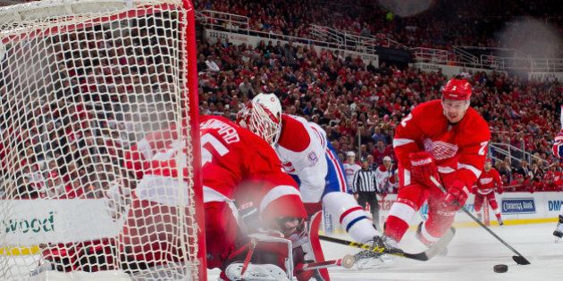 DETROIT, MI - FEBRUARY 16: Goalie Jimmy Howard #35 of the Detroit Red Wings makes a save on Brandon Prust #8 of the Montreal Canadiens as teammate Brendan Smith #2 pressures him during a NHL game on February 16, 2015 at Joe Louis Arena in Detroit, Michigan. (Photo by Dave Reginek/NHLI via Getty Images)