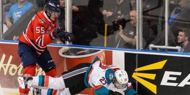 QUEBEC CITY, QC - MAY 31: Michael McCarron #55 of the Oshawa Generals checks Josh Morrissey #27 of the Kelowna Rockets during the 2015 Memorial Cup Championship at the Pepsi Coliseum on May 31, 2015 in Quebec City, Quebec, Canada. (Photo by Minas Panagiotakis/Getty Images)