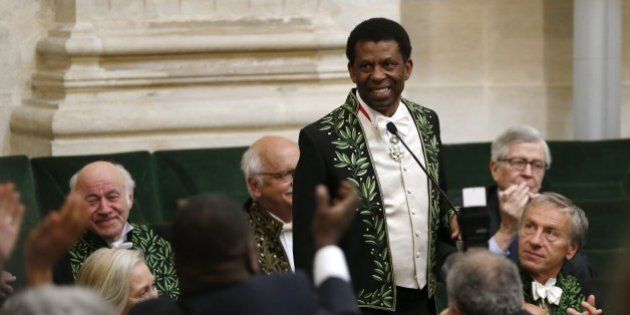 Haitian Canadian writer Dany Laferriere wearing his Academician suit, is applauded on May 28, 2015 in Paris, during his official entry ceremony as member of the prestigious Academie Francaise (French Academy), the body which has the task of acting as an official authority on the French language. Laferriere won the 2009 Prix Medicis, one of France's top literary awards for his book 'L'enigme du retour' (The riddle of return). Laferriere is the first Haitian-born and French Canadian to be admitted at the Academie francaise. He will sit on the chair Number 2, which was once the chair of French writer and political philosopher Montesquieu (1689-1755). AFP PHOTO / THOMAS SAMSON (Photo credit should read THOMAS SAMSON/AFP/Getty Images)