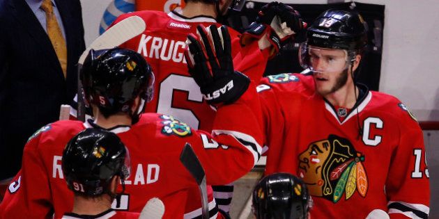 Chicago Blackhawks center Jonathan Toews, right, congratulates teammates after beating the Anaheim Ducks 5-2 in Game 6 of the Western Conference finals of the NHL hockey Stanley Cup playoffs, Wednesday, May 27, 2015, in Chicago. The Blackhawks won 5-2. (AP Photo/Charles Rex Arbogast)