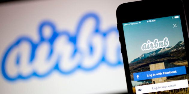 The Airbnb Inc. application and logo are displayed on an Apple Inc. iPhone and iPad in this arranged photograph in Washington, D.C., U.S., on Friday, March 21, 2014. Airbnb Inc. is raising money from investors including TPG Capital in a financing round that would value the room-sharing service at more than $10 billion, said people with knowledge of the deal. Photographer: Andrew Harrer/Bloomberg via Getty Images