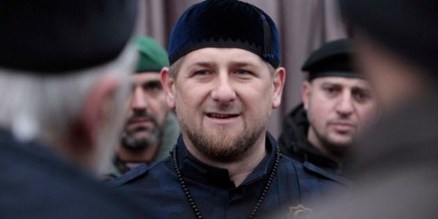 Chechnya's regional leader Ramzan Kadyrov, center, speaks to Chechen top commanders while inspecting Chechen special forces in Grozny, Russia, Sunday, Dec. 28, 2014. About 20,000 armed security forces attend a rally at a stadium in Chechen capital Grozny. Kadyrov said that Chechens could serve as