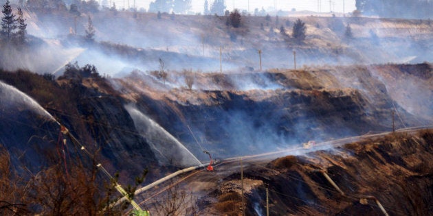 In this Feb. 25, 2014, photo provided by the Incident Control Centre, a fire burns at the Hazelwood Coal Mine at Morwell, Australia. Victoria state Chief Health Officer Rosemary Lester said Friday, Feb. 28, 2014, that vulnerable residents are advised to leave the town of Morwell as a precaution because the fire in the nearby mine is expected to spew smoke for at least 10 more days. (AP Photo/Incident Control Centre) EDITORIAL USE ONLY