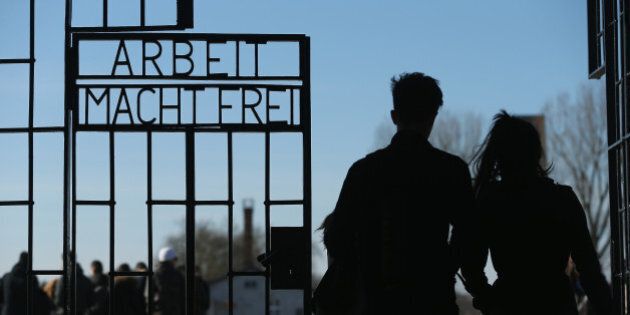 ORANIENBURG, GERMANY - MARCH 18: Visitors walk through the infamous 'Arbeit Macht Frei' ('Work Makes Free') inscription at the original entrance gate to the former Sachsenhausen concentration camp near Berlin on March 18, 2015 in Oranienburg, Germany. The Nazis ran Sachsenhausen from 1936-1945, using it initially for political prisoners, then later also for Soviet prisoners of war, Jews, homosexuals, Jehova's Witnesses and other victims. The camp included a gas chamber, execution pit and ovens for burning bodies, and an estimated 30,000 inmates died. Germany will soon commemorate the 70th anniversary of the April 22, 1945 liberation of the camp by Soviet and Polish soldiers. (Photo by Sean Gallup/Getty Images)