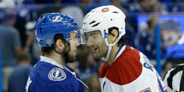 Tampa Bay Lightning right wing Nikita Kucherov (86) of Russia, and Montreal Canadiens left wing Max Pacioretty (67) jostle during second period of Game 4 NHL second round playoff hockey action, Thursday, May 7, 2015, in Tampa, Fla. (AP Photo/Wilfredo Lee)