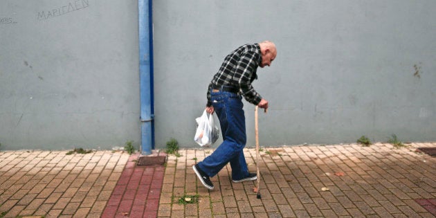 A man holds a bag with food as he leaves a New Year's meal for homeless organized by municipality of Athens, on Thursday, Jan. 1, 2015. Homelessness has increased dramatically during the financial crisis in Greece, which has depended on international rescue loans for more than four years. The campaign for Greece's general election is now underway, with the country's conservative prime minister claiming his anti-bailout opponents would