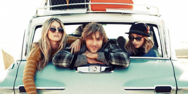 Friends hanging out in the back of a car.