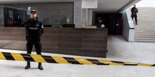 TUNIS, TUNISIA - MARCH 19: Tunisian police stand near the crime scene outside the National Bardo Museum in Tunis on March 19, 2015 after the attack at museum. At least 23 people, including 20 foreign tourists, were killed when gunmen stormed Tunis' Bardo Museum on Wednesday. (Photo by Amine Landoulsi/Anadolu Agency/Getty Images)