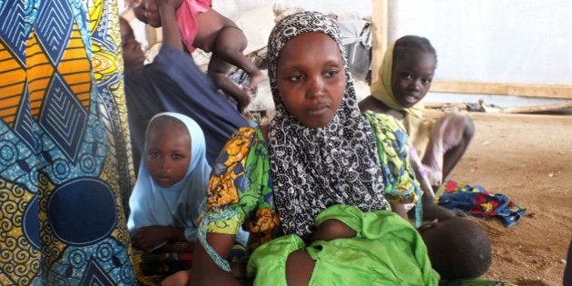 In this photo taken on Wednesday, Feb. 25, 2015, A family of refugees that fled their homes due to violence from the Islamic extremists group Boko Haram inside a refugee camp in Minawao, Cameroon. Cameroon officials say prisons are overcrowded with suspected Islamic extremists whose insurgency has spilled from Nigeria. (AP Photo/Edwin Kindzeka Moki)