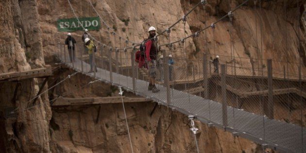 Journalists walk during a visit to the foot-path 'El Caminito del Rey' (King's little path) a narrow walkway hanging and carved on the steep walls of a defile in Ardales near Malaga on March 15, 2015. The one meter wide and 7.7 km long path, hanging from Ardales' defile at 100 meter high, was closed in the mid 90's after several hikers resulted dead when walking it. Once restored it will be reopened to the public on March 28, 2015. AFP PHOTO/ JORGE GUERRERO (Photo credit should read Jorge Guerrero/AFP/Getty Images)