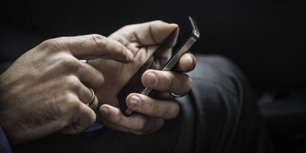Close up of businessman using cell phone