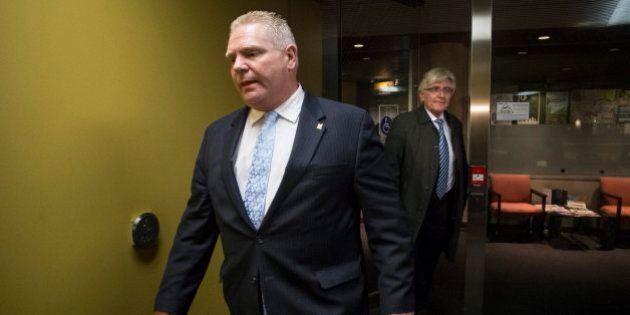 Toronto City Councillor Doug Ford walks out of his office with City Manager Joe Panachetti after Toronto councillor's had voted to limit the power of Mayor Rob Ford on Monday November 18, 2013.THE CANADIAN PRESS/Chris Young