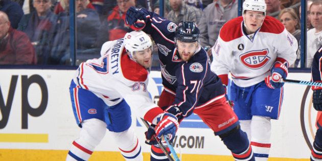 COLUMBUS, OH - FEBRUARY 26: Max Pacioretty #67 of the Montreal Canadiens and Nick Foligno #71 of the Columbus Blue Jackets reach for a loose puck during the first period on February 26, 2015 at Nationwide Arena in Columbus, Ohio. (Photo by Jamie Sabau/NHLI via Getty Images)