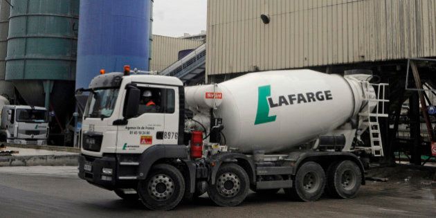 FILE PHOTO: A Lafarge cement mixer truck is driven from the refilling station at Lafarge SA's depot in Paris, France, on Thursday, Feb. 16, 2012. Holcim Ltd. and Lafarge SA agreed a merger to create the worlds biggest cement maker with more than $40 billion in sales and cut overcapacities and energy expenses. Photographer: Fabrice Dimier/Bloomberg via Getty Images