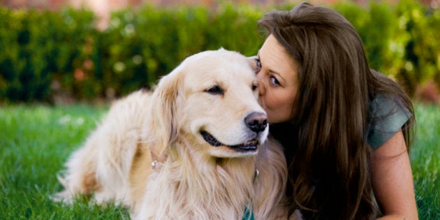 Woman kissing dog