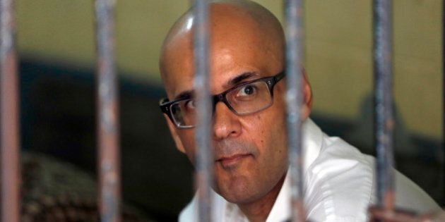 Canadian teacher Neil Bantleman sits inside a holding cell prior to the start of his trial hearing to listen to the prosecutor's demand at South Jakarta District Court in Jakarta, Indonesia, Thursday, March 12, 2015. Bantleman and Indonesia teaching assistant Ferdinant Tjiong were on trial on accusation of sexually abusing a kindergartner on the campus of a prestigious international school in the capital. (AP Photo/Dita Alangkara)