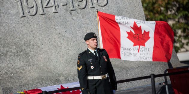OTTAWA, ON - OCTOBER 24: A soldier in the Canadian Army stands guard at the National War Memorial during a ceremony at the memorial on October 24, 2014 in Ottawa, Canada. Two days ago a gunman killed Cpl. Nathan Cirillo, a soldier guarding the memorial. The gunman then stormed the main parliament building, terrorizing the public and politicians, before he was shot dead. (Photo by Andrew Burton/Getty Images)