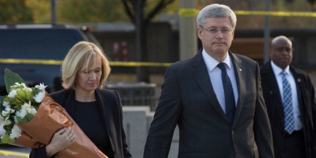 OTTAWA, CANADA - OCTOBER 23: In this handout photo provided by the PMO, Prime Minister Stephen Harper (R) and his wife Laureen Harper arrive at the National War Memorial to lay flowers in honour of Corporal Nathan Cirillo who was killed yesterday while standing guard at the memorial, on October 23, 2014 in Ottawa, Canada. After killing Cirillo the gunman stormed the main parliament building, terrorizing the public and politicians, before he was shot dead. (Photo by Jason Ransom/PMO via Getty Images)