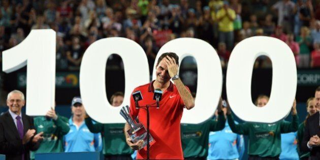 Roger Federer of Switzerland reacts as he celebrates the 1000th victory of his career after beating Milos Raonic of Canada in the men's single final of the Brisbane International tennis tournament in Brisbane on January 11, 2015. AFP PHOTO / Saeed KHANIMAGE RESTRICTED TO EDITORIAL USE - STRICTLY NO COMMERCIAL USE (Photo credit should read SAEED KHAN/AFP/Getty Images)