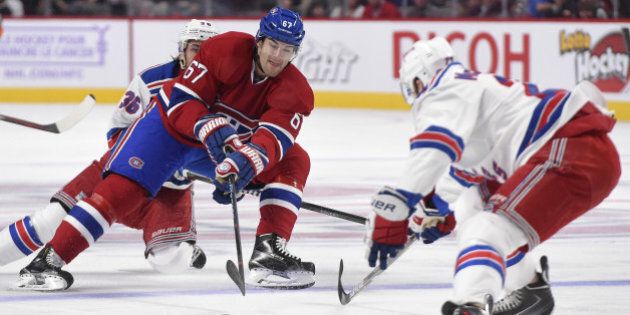MONTREAL, QC - OCTOBER 25: Max Pacioretty #67 of the Montreal Canadiens controls the puck being challenged by Mats Zuccarello #36 and Ryan McDonagh #27 of the New York Rangers in the NHL game at the Bell Centre on October 25, 2014 in Montreal, Quebec, Canada. (Photo by Francois Lacasse/NHLI via Getty Images)