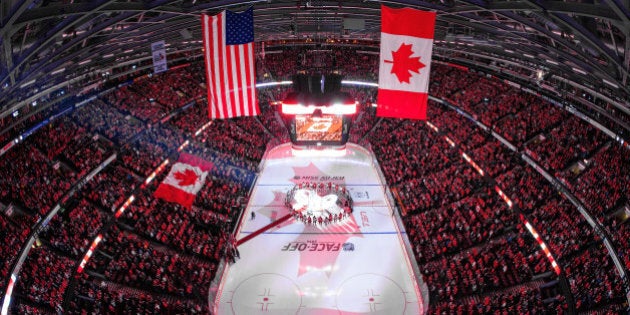 OTTAWA, ON - OCTOBER 25: In a coordinated tribute with NHL games in Montreal and Toronto to honor Canadian soldiers who lost their lives this past week, members of the Ottawa Senators and the New Jersey Devils stand together at center ice for the national anthems at Canadian Tire Centre on October 25, 2014 in Ottawa, Ontario, Canada. (Photo by Andre Ringuette/NHLI via Getty Images)