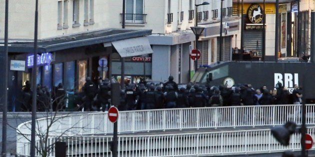 Members of the French special police forces launch the assault at a kosher grocery store in Porte de Vincennes, eastern Paris, on January 9, 2015 where at least two people were shot dead on January 9 during a hostage-taking drama at a Jewish supermarket in eastern Paris, and five people were being held, official sources told AFP. Several hostages were freed after French commandos stormed a Jewish supermarket in eastern Paris where an assailant was holed up on January 9. After several explosions, police stormed the shop in Portes de Vincennes and everal hostages exited the store shortly afterwards and were taken to safety. AFP PHOTO / THOMAS SAMSON (Photo credit should read THOMAS SAMSON/AFP/Getty Images)