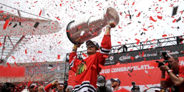 Chicago Blackhawks defenseman Niklas Hjalmarsson, of Sweden, holds up the Stanley Cup during a rally celebrating the NHL hockey club's Stanley Cup championship, Thursday, June 18, 2015, at Soldier Field in Chicago.(AP Photo/Nam Y. Huh)