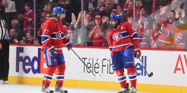 MONTREAL, QC - OCTOBER 18: P.K. Subban #76 of the Montreal Canadiens celebrates with Tom Gilbert #77 his second goal of the night against the Colorado Avalanche in the NHL game at the Bell Centre on October 18, 2014 in Montreal, Quebec, Canada. (Photo by Francois Lacasse/NHLI via Getty Images)