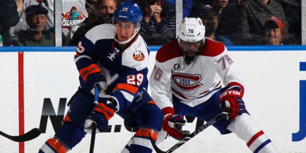UNIONDALE, NY - DECEMBER 23: P.K. Subban #76 of the Montreal Canadiens and Brock Nelson #29 of the New York Islanders vie for the puck in the first period at Nassau Veterans Memorial Coliseum on December 23, 2014 in Uniondale, New York. (Photo by Bruce Bennett/Getty Images)