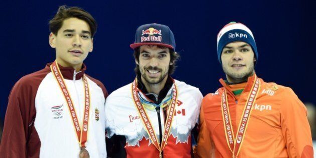 (L-R) Bronze medalist Hungary's Shaolin Sandor Liu, gold medalist Canada's Charles Hamelin and bronze medalist the Netherland's Sjinkie Knegt (2nd) pose during the awards ceremony after the men's 1000 metre final at the ISU World Cup Short Track speed skating event in Shanghai on December 14, 2014. AFP PHOTO / JOHANNES EISELE (Photo credit should read JOHANNES EISELE/AFP/Getty Images)