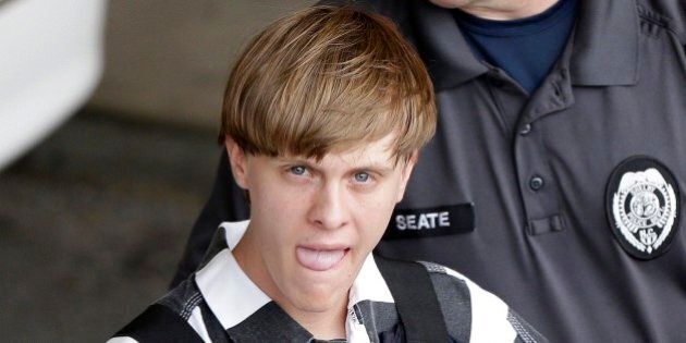 Charleston, S.C., shooting suspect Dylann Storm Roof is escorted from the Cleveland County Courthouse in Shelby, N.C., Thursday, June 18, 2015. Roof is a suspect in the shooting of several people Wednesday night at the historic The Emanuel African Methodist Episcopal Church in Charleston. The current brick Gothic revival edifice, completed in 1891 to replace an earlier building heavily damaged in an earthquake, was a mandatory stop for the likes of Booker T. Washington and the Rev. Martin Luther King Jr. Still, Emanuel was not just a church for the black community.(AP Photo/Chuck Burton)