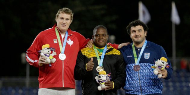 Left to right: silver medalist Timothy Nedow of Canada, gold medalist O'Dayne Richards of Jamaica and bronze medalist German Lauro of Argentina pose during the medals ceremony of the men's shot put final at the Pan Am Games in Toronto, Ontario, Tuesday, July 21, 2015. (AP Photo/Felipe Dana)