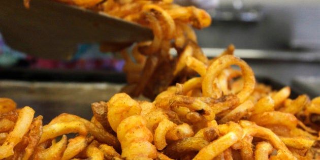 FILE - In this Sept. 14, 2011 file photo, fresh fries are scooped into containers during lunch at Gardiner High School in Gardiner, Maine. Congress wants to keep pizza and french fries on school lunch lines, fighting back against an Obama administration proposal to make school lunches healthier. The final version of a spending bill released late Monday would unravel school lunch standards the Agriculture Department proposed earlier this year, which included limiting the use of potatoes on the lunch line and delaying limits on sodium and delaying a requirement to boost whole grains. (AP Photo/Pat Wellenbach)