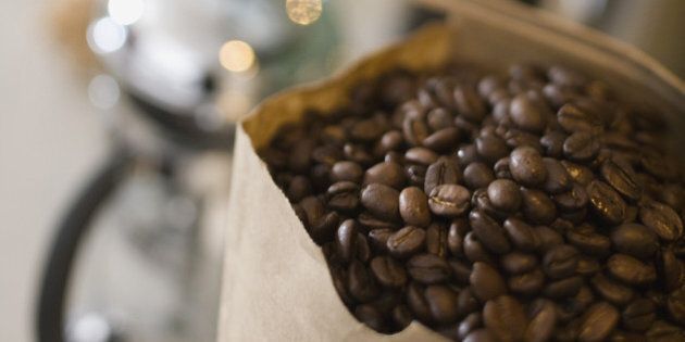 Bag of coffee beans with coffee maker