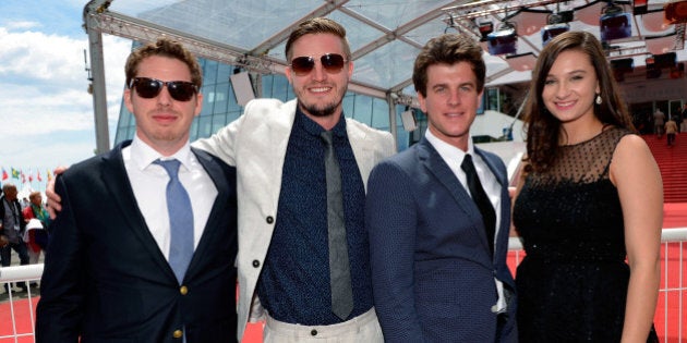 CANNES, FRANCE - MAY 21: (L-R) Director of photography Zach Graber, producer Tyler Reid, director Ryan Curtis and subject of 'Ovation For Oscar' Sloane Mayberry pose in front of the red carpet after the 'SCAD Presents Cannes Documentary Screening for Ovation For Oscar' at Palais des Festivals on May 21, 2015 in Cannes, France. (Photo by Luca Teuchmann/Getty Images for SCAD)