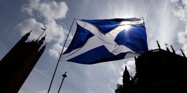 The Scottish flag flies above Parliament in Westminster, London, Monday, May 11, 2015. The separatist Scottish National Party gained an unprecedented landslide victory in the race for seats in the British Parliament, winning 56 of Scotland's 59 seats. (AP Photo/Kirsty Wigglesworth)