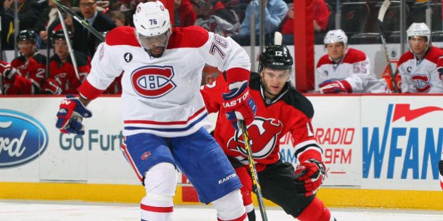 NEWARK, NJ - JANUARY 02: P.K. Subban #76 of the Montreal Canadiens controls the puck while being pursued by Tim Sestito #12 of the New Jersey Devils during the game at the Prudential Center on January 2, 2015 in Newark, New Jersey. (Photo by Andy Marlin/NHLI via Getty Images)
