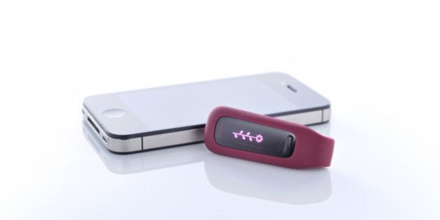 A Fitbit One fitness tracker and Apple iPhone 4S smartphone photographed during a studio shoot for Tap Magazine, November 28, 2012. (Photo by Simon Lees/Tap Magazine via Getty Images)