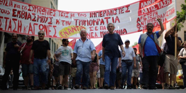 ATHENS, GREECE - JULY 11: Anti-austerity demonstrators, from the communist party, take part in a minor rally through the streets of Athens on July 11, 2015 in Athens, Greece. Greek Prime Minister Alexis Tsipras has won the backing of parliament with the new debt proposal which has been given to Greece's creditors - the European Commission, the European Central Bank and the International Monetary Fund. European leaders will meet on Sunday to decide on the country's fate and whether it should stay in the euro. (Photo by Christopher Furlong/Getty Images)