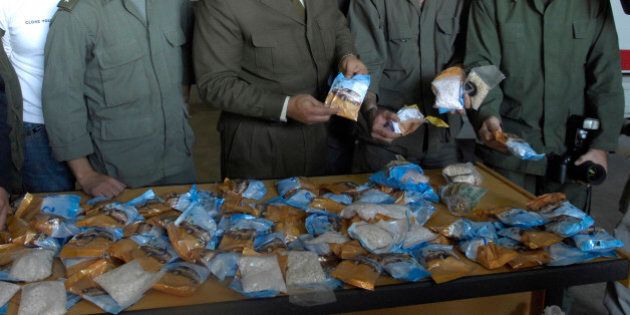 Lebanese customs officers display confiscated drugs of Captagon pills found in a bus, at Beirut Port, in Lebanon, Monday, Nov. 26, 2007. Lebanese customs authorities on Monday confiscated more than two million smuggled tranquilizer pills that were brought from Syria and were to be sent to the wealthy Gulf state of Qatar through Lebanon, state-run National News Agency and security officials said.(AP Photo/Ahmad Omar)